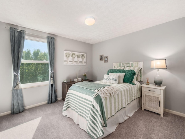 carpeted bedroom featuring a textured ceiling