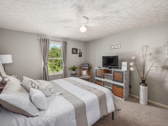 bedroom with carpet, a textured ceiling, and ceiling fan