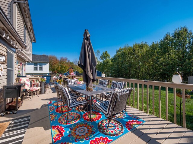 wooden terrace featuring a yard