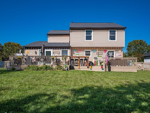 back of property with a wooden deck and a lawn