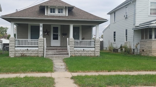 bungalow-style home with cooling unit and a porch