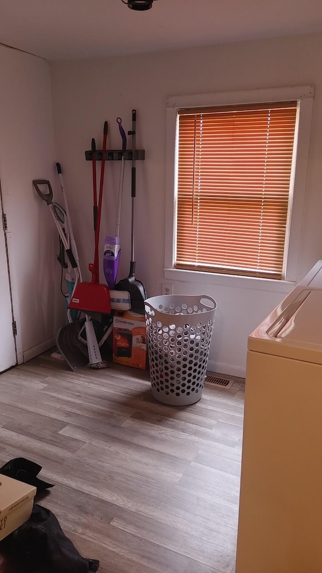 living area featuring washer / clothes dryer and light hardwood / wood-style flooring