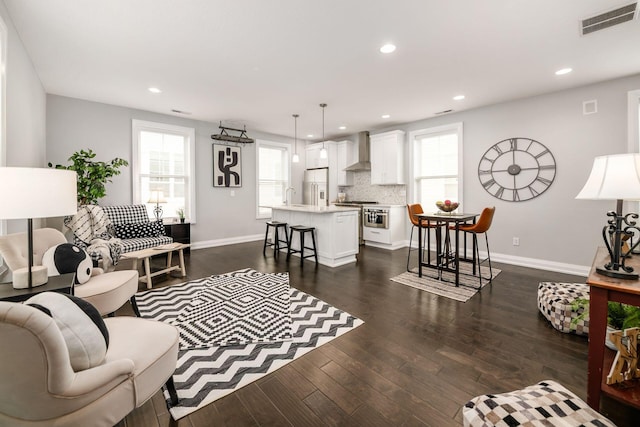 1002 Ewing Aly, Columbus, OH 43201 - living room with healthy amount of natural light, baseboards, recessed lighting, and dark wood-style flooring