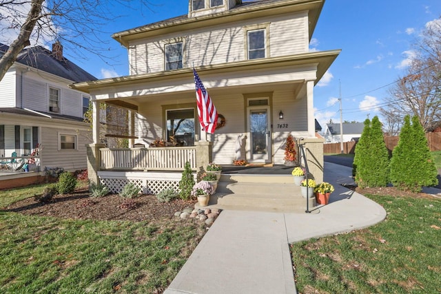 view of front property featuring a porch and a front yard