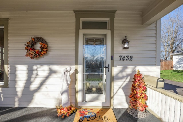 view of exterior entry with a porch