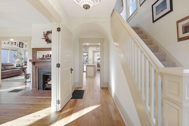 corridor with light hardwood / wood-style floors