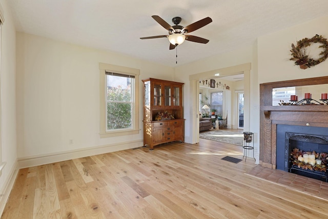 unfurnished living room featuring light hardwood / wood-style flooring and ceiling fan