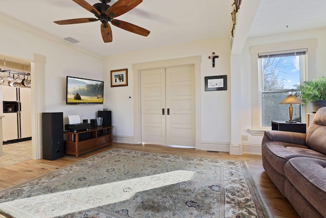 living room with hardwood / wood-style floors and ceiling fan