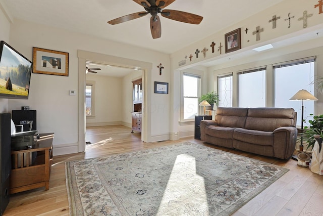 living room featuring light hardwood / wood-style floors and ceiling fan