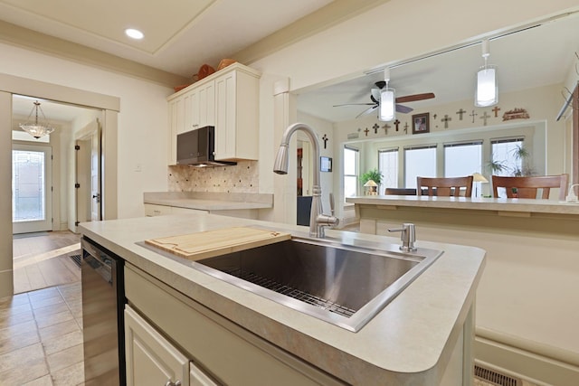 kitchen featuring tasteful backsplash, sink, decorative light fixtures, dishwasher, and white cabinetry