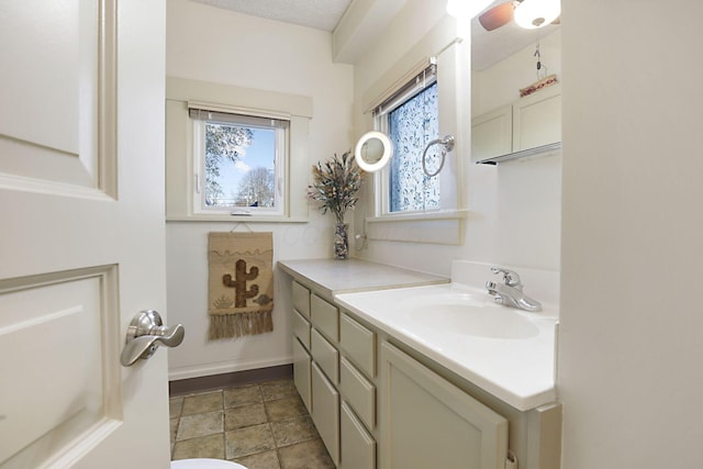 bathroom featuring a textured ceiling and vanity