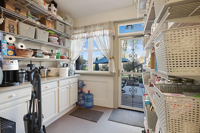 laundry area featuring light carpet