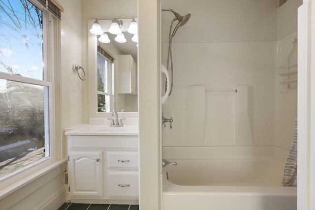 bathroom with tile patterned floors, plenty of natural light, shower / tub combination, and vanity