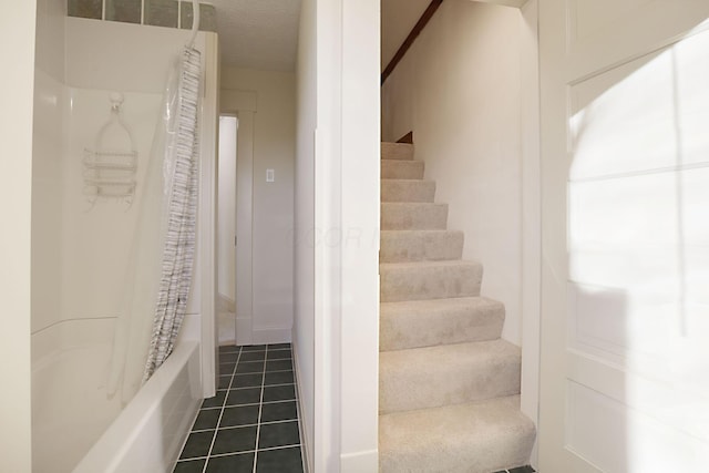 stairs featuring tile patterned floors