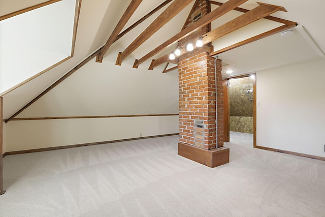 additional living space featuring beam ceiling, ornate columns, and light carpet