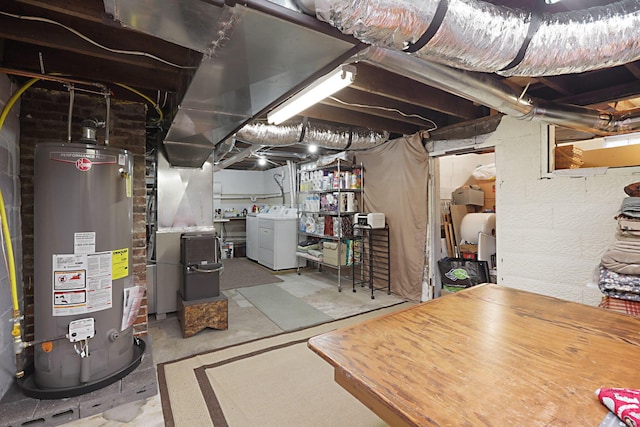 basement featuring washer and dryer, gas water heater, and heating unit