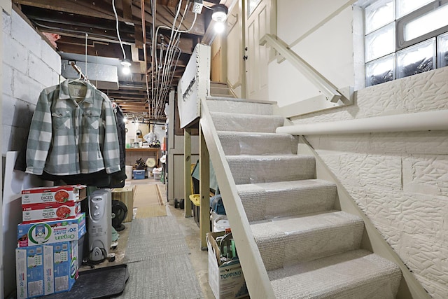 stairs featuring concrete flooring