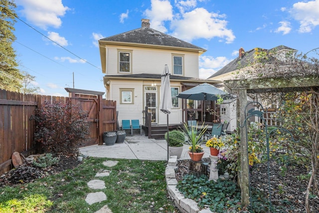 rear view of property featuring a patio