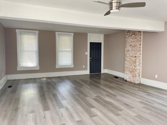 spare room with light wood-type flooring and ceiling fan