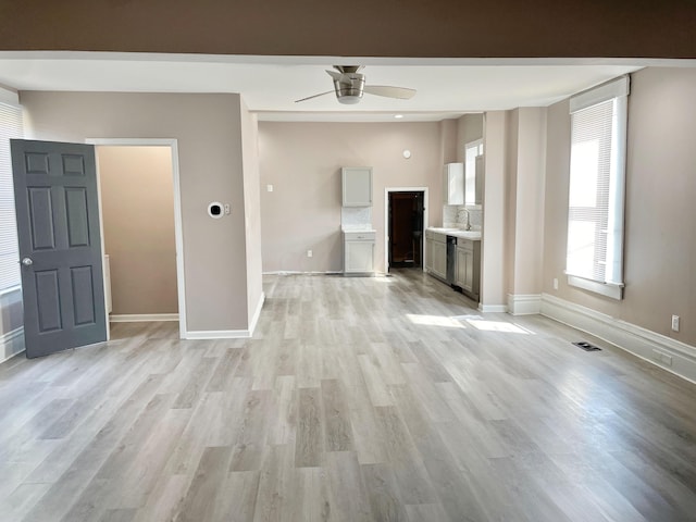 unfurnished living room with ceiling fan and light hardwood / wood-style flooring