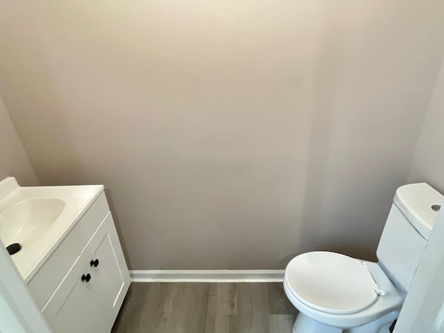 bathroom featuring vanity, toilet, and wood-type flooring