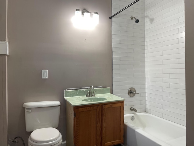 full bathroom with vanity, tiled shower / bath combo, and toilet