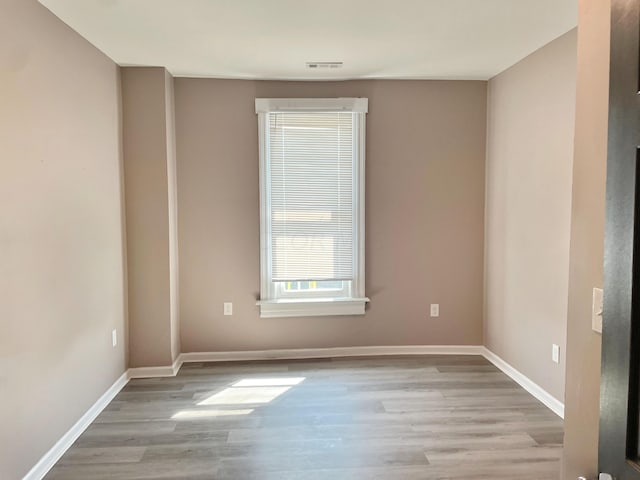 unfurnished room with light hardwood / wood-style floors