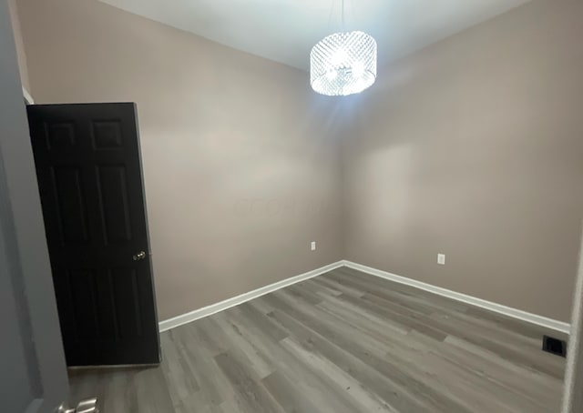 unfurnished room with hardwood / wood-style flooring