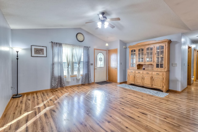 entrance foyer featuring ceiling fan, light hardwood / wood-style flooring, and vaulted ceiling