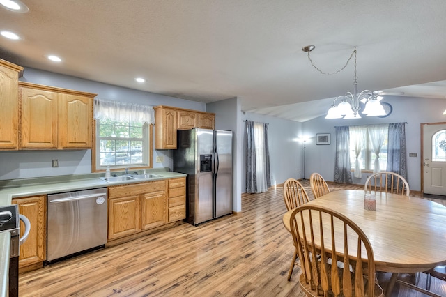 kitchen with sink, a healthy amount of sunlight, a notable chandelier, and appliances with stainless steel finishes