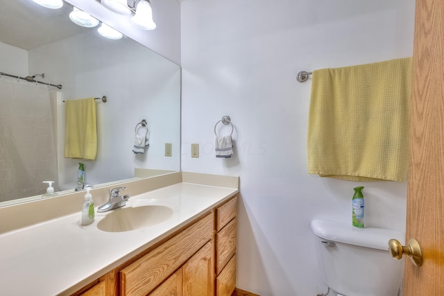 bathroom with vanity, a shower with shower curtain, and toilet