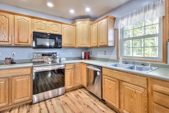 kitchen featuring light hardwood / wood-style flooring, stainless steel appliances, and sink