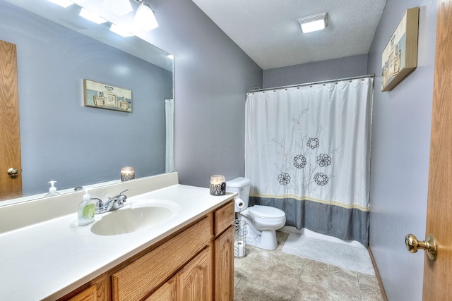 full bathroom with shower / tub combo with curtain, vanity, a textured ceiling, and toilet