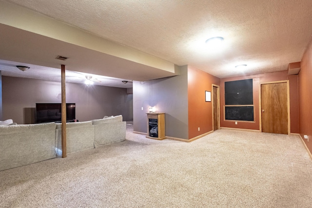 basement featuring carpet flooring and a textured ceiling