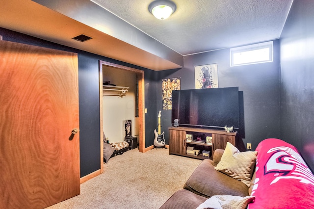 carpeted living room featuring a textured ceiling