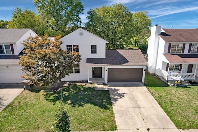 view of front of property with a front yard and a garage