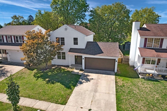 view of front of home with a front yard and a garage