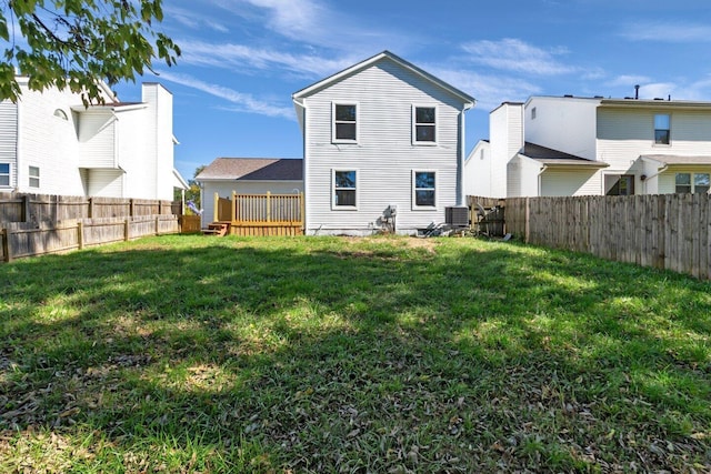 back of house with a wooden deck, a yard, and cooling unit