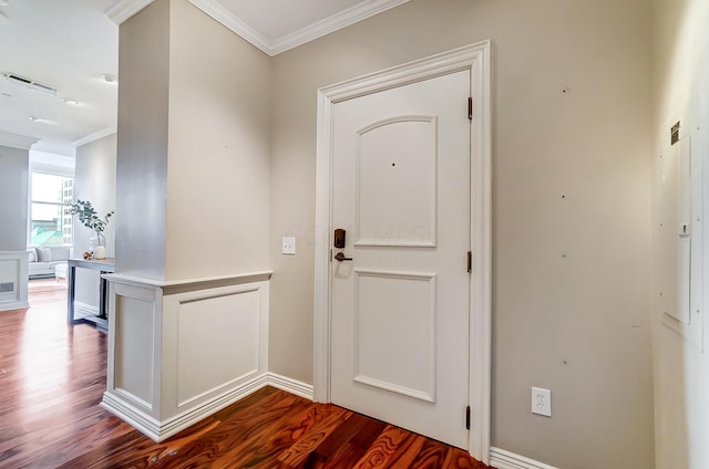 entryway with hardwood / wood-style floors and crown molding