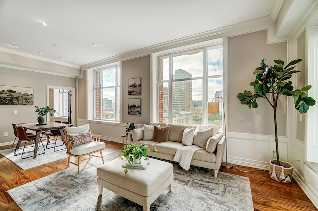 living room featuring a wealth of natural light, crown molding, and wood-type flooring