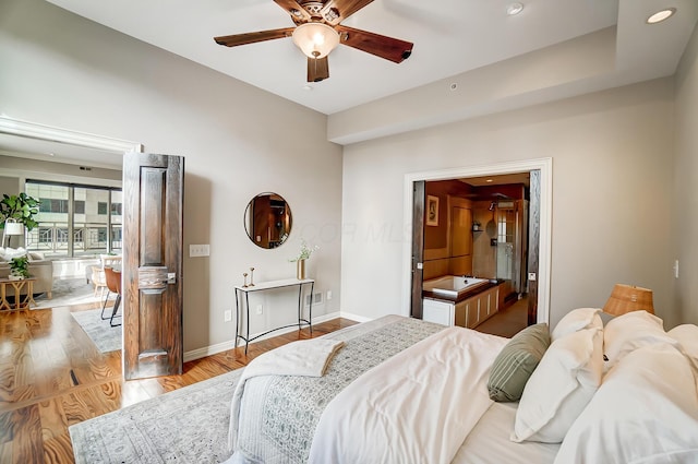 bedroom with light hardwood / wood-style flooring and ceiling fan