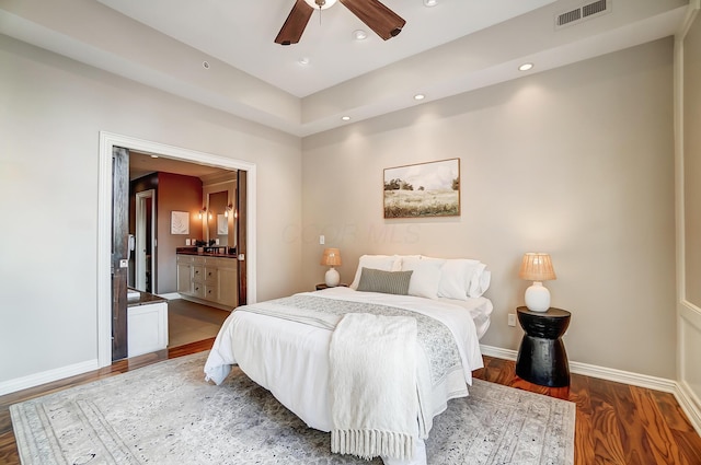 bedroom with ceiling fan, dark hardwood / wood-style flooring, and ensuite bathroom