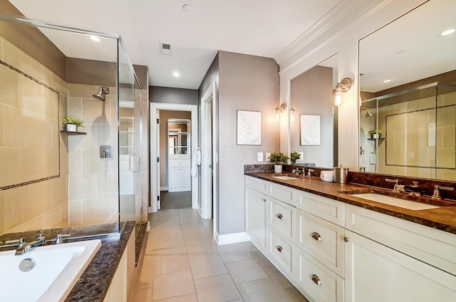 bathroom with tile patterned flooring, vanity, and independent shower and bath