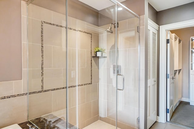 bathroom with tile patterned flooring and an enclosed shower