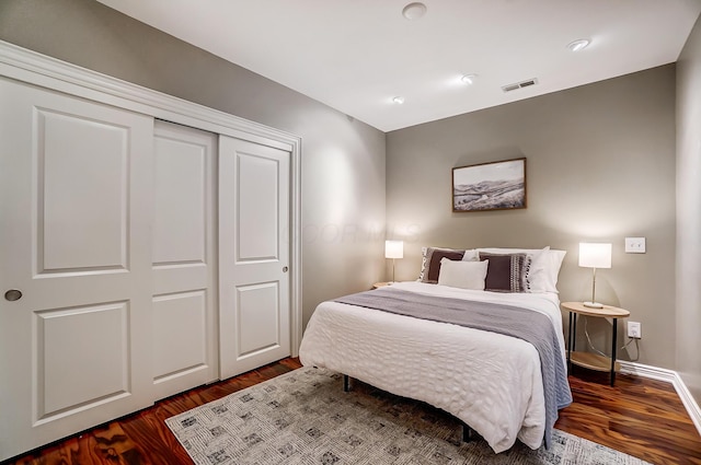 bedroom featuring dark hardwood / wood-style floors and a closet