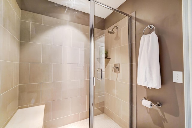 bathroom featuring a shower with shower door