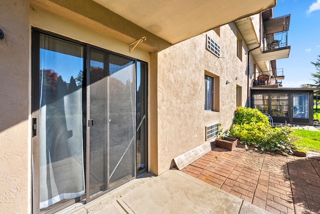 doorway to property featuring a patio area