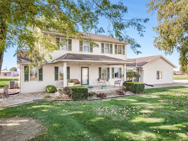 view of front of property featuring central AC and a front yard