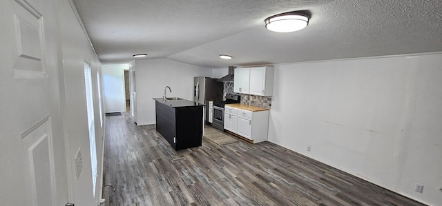 kitchen with wall chimney range hood, sink, stainless steel range oven, dark hardwood / wood-style floors, and white cabinetry