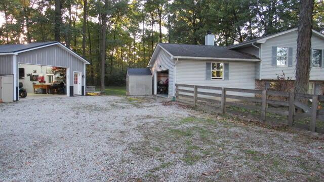 view of side of home with an outbuilding and a garage